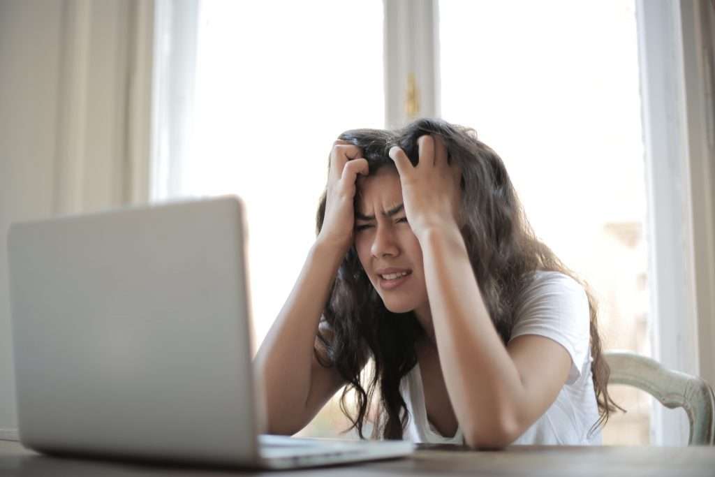 stressed teen looking at a computer