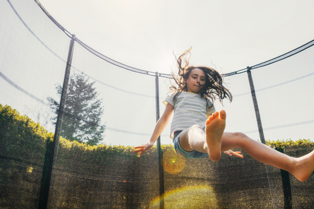 Girl bouncing on trampoline instead of using a screen