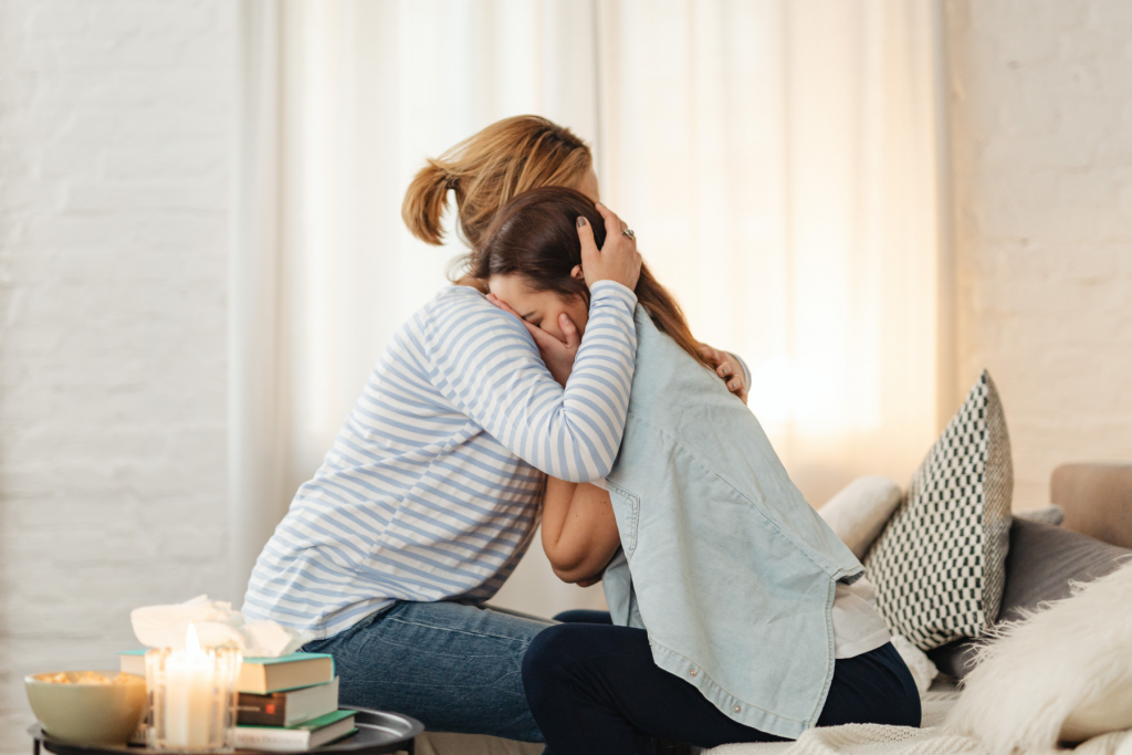 Mom hugging crying teen